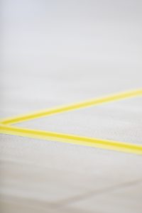 A cable underneath tape is pictured - this is how markings are put on the goalball court.