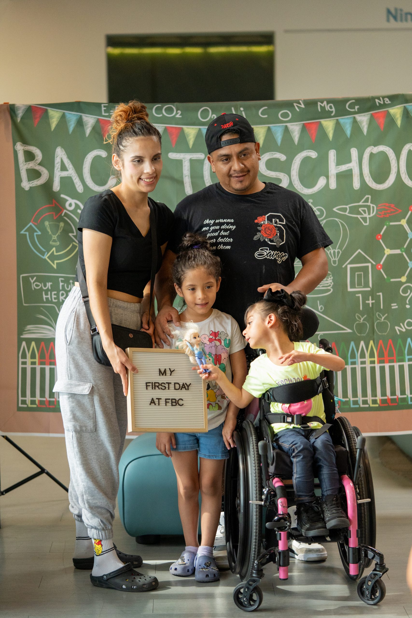 A family of four smiles at the camera while at FBC’s main campus.