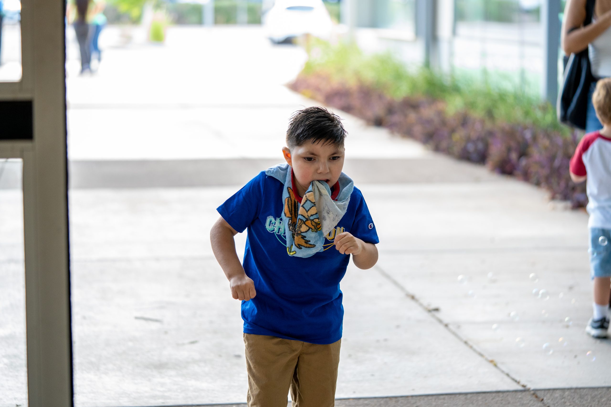 A young boy walks through a balloon arch at the main FBC building.
