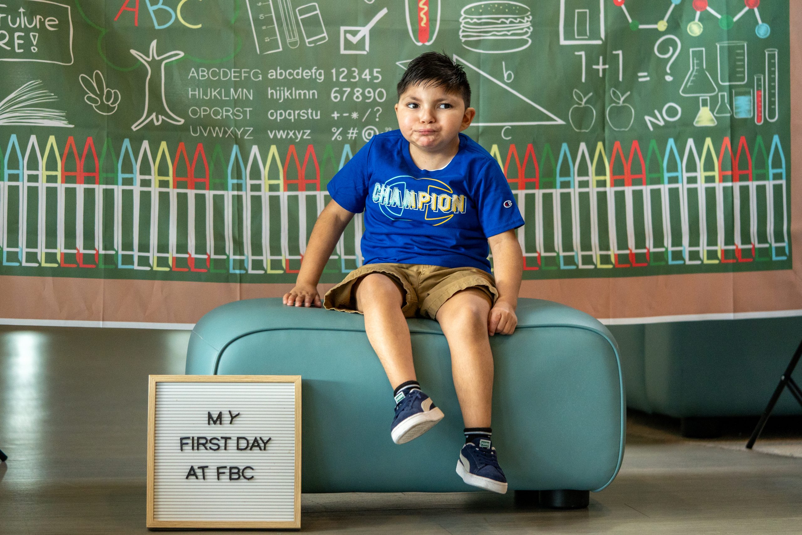 A young boy smiles for the camera at FBCs main building