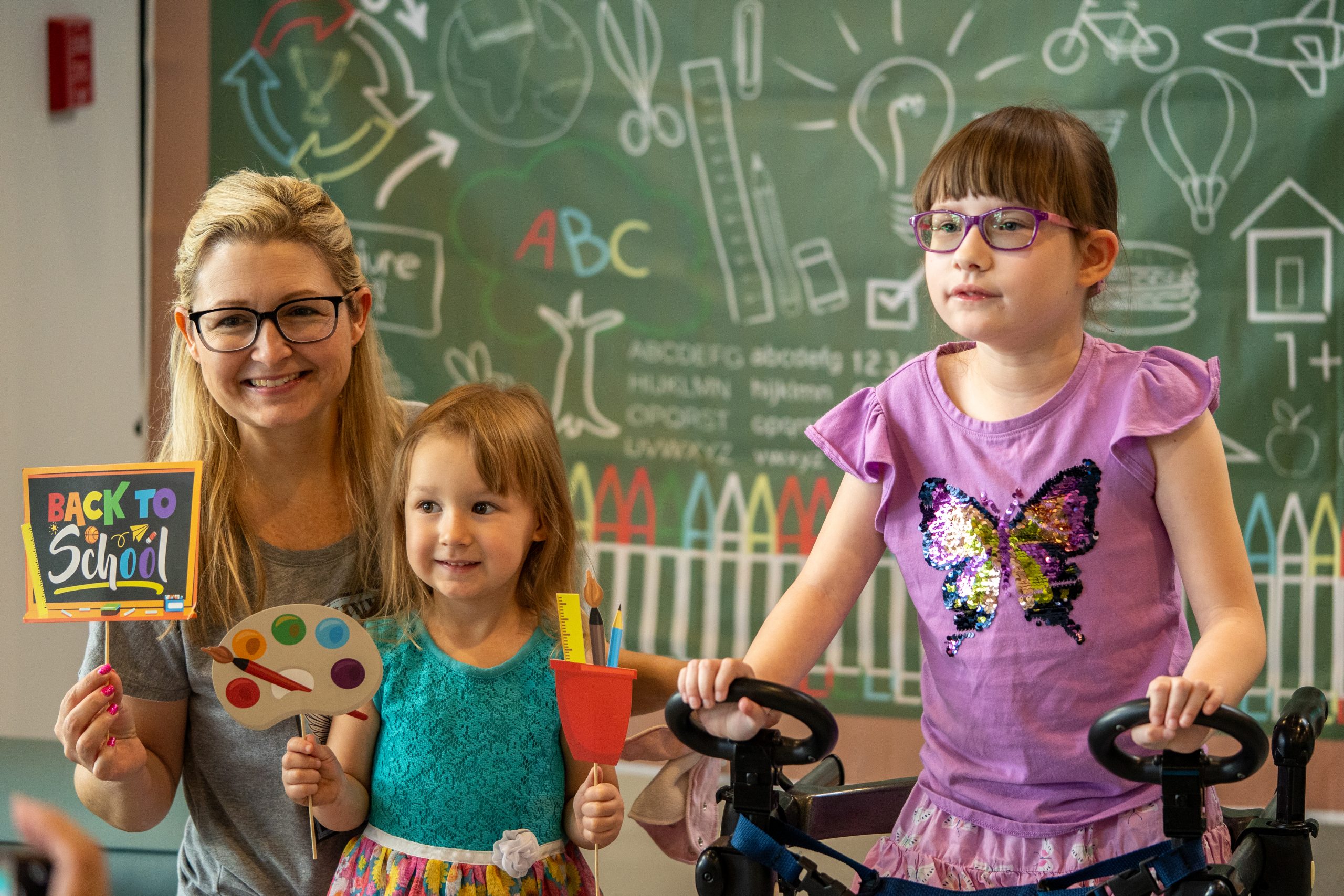 A mother and her two daughters smile for the camera at FBCs main campus