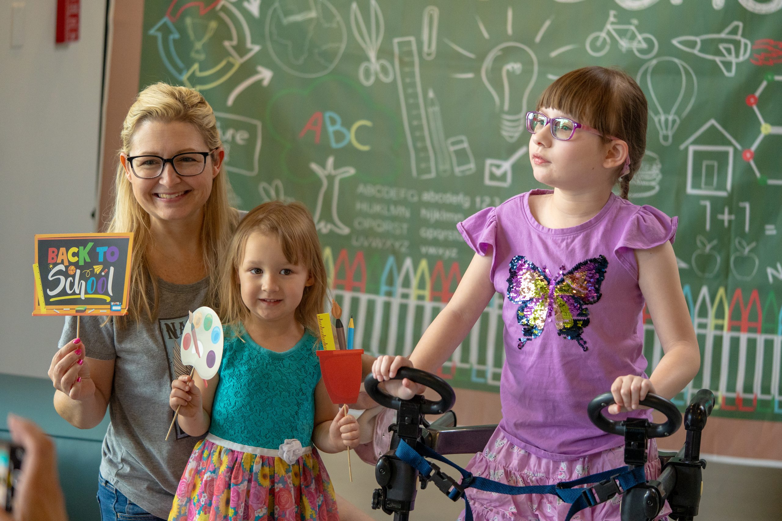 A mother and her two daughters smile for the camera at FBCs main campus