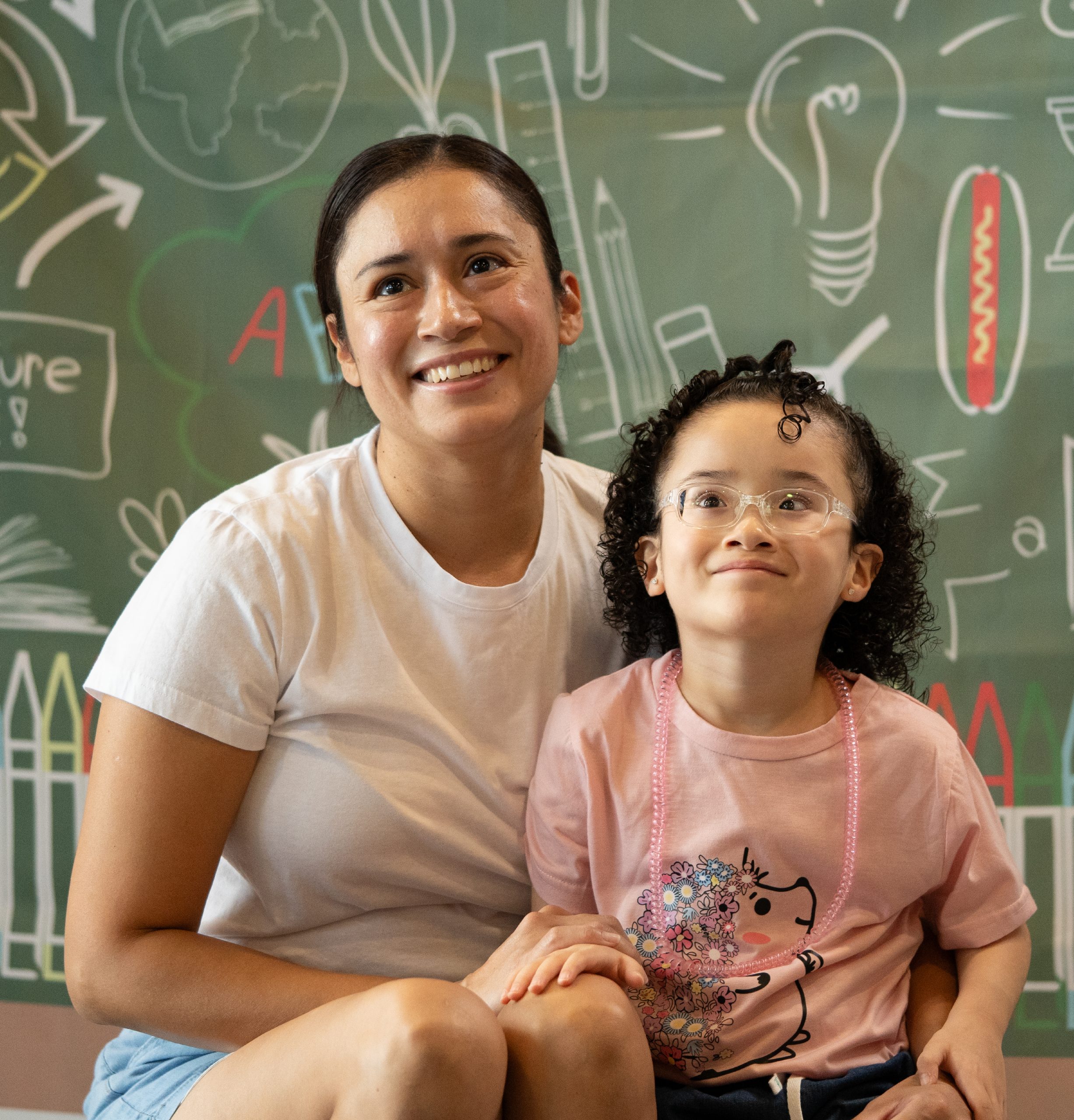 Mother and daughter smile for the camera on the first day of school at FBC's main campus